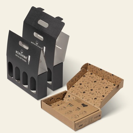 Black die-cut bottle carriers with cut handles, beside an open printed mailer tray